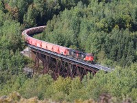 CN 3113 leads a 2 + 2 setup B730 potash unit train across the viaduct at St-Eleuthere, Qc along the Pelletier Sub heading for Saint John,NB.  Today the train has 124 Potash Corp cars and 1 Canpotex making the 125 car train 18715 tons and just over 6100 feet in length.
This train originates in Saskatchewan as 205 car lengths, at 30142 tons and 9931 feet.  This train is shortened at Joffre yard due to the Subdivions max tonnage.
You can view the video of the entire train here.  https://www.youtube.com/watch?v=BSlwmOTWoP4
