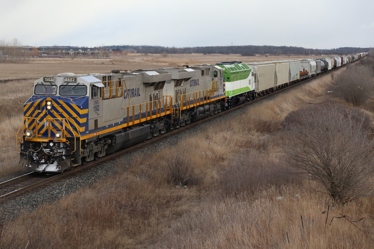 A very colourful CN 394 with a pair of leased CREX ES 44's and brand new GO Transit 668 roll eastward at the south end of Milton.