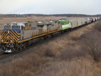 A very colourful CN 394 with a pair of leased CREX ES 44's and brand new GO Transit 668 roll eastward at the south end of Milton.