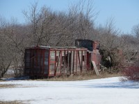 This caboose and bunk car were once part of a boy scout camp. Time has not been kind, but it has survived one more winter.