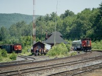 Rare that I saw much action around CP's Mattawa Station, unless it was a passing CP freight. On this day I decided to wander by on account the Rail Link annual picnic was taking place, a trek out to Mattawa station by train from North Bay. With a couple of passenger coaches, at least this was something a little different. So hung around a lot of the day, and did get a couple of CP trains roaring by, but the lighting there is a bit tricky, especially with the large station roof overhang that casts a dark shadow on the structure below it. As luck would have it this day, the Tembec Turn was returning from Temiscaming behind RLK 3586 and 5006, which resulted in having me scurry somewhere to grab a photo of a train on the CP North Bay sub as well as one on the CP Temiscaming Sub, the junction being just off to the left of me in this photo. It was one heck of a hot day as well, noted by the fact 3509s 'a/c' is open.The two leaders seen are x-CN MLWs, the 5006 trailing on the Turn is an x-CP GP35.