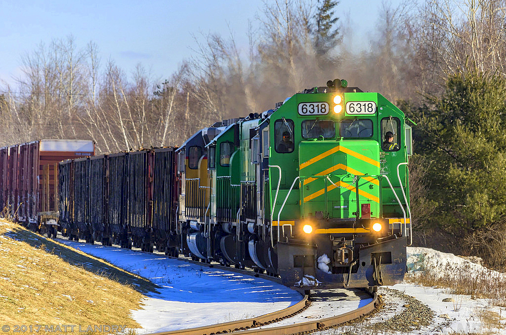 After doing a set off/pick up at Fredericton Jct, westbound NBSR train 907 continues on, as they round the bend at Tracy, New Brunswick.