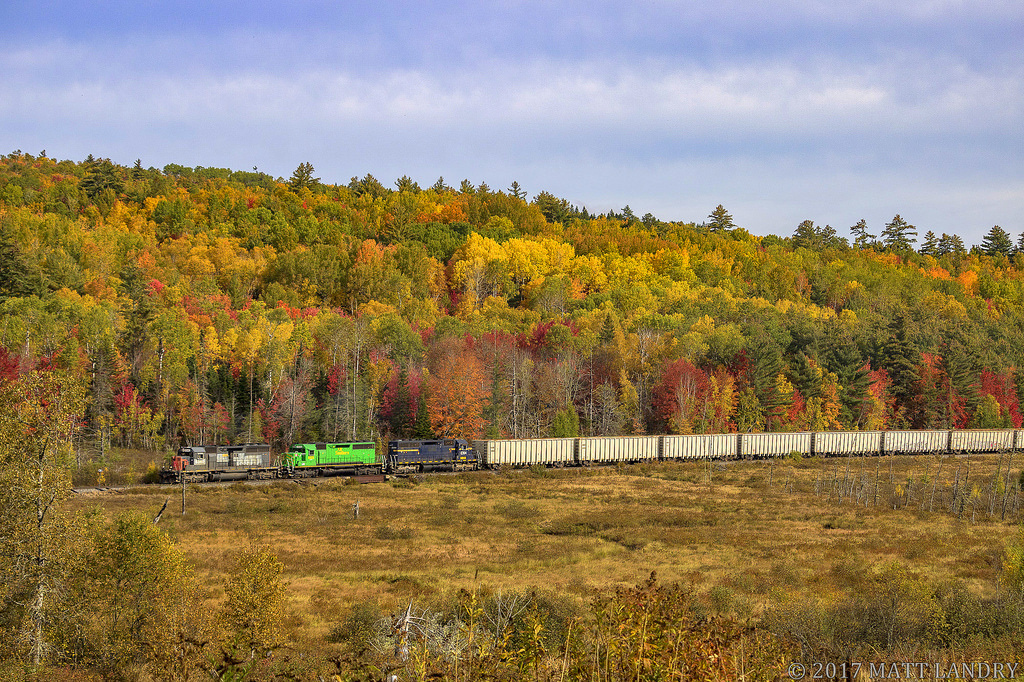 With the Fall colors finally starting to show, NBSR 6340, ex Southern Pacific, leads a somewhat colorful New Brunswick Southern railway westbound freight at Clarendon, New Brunswick.