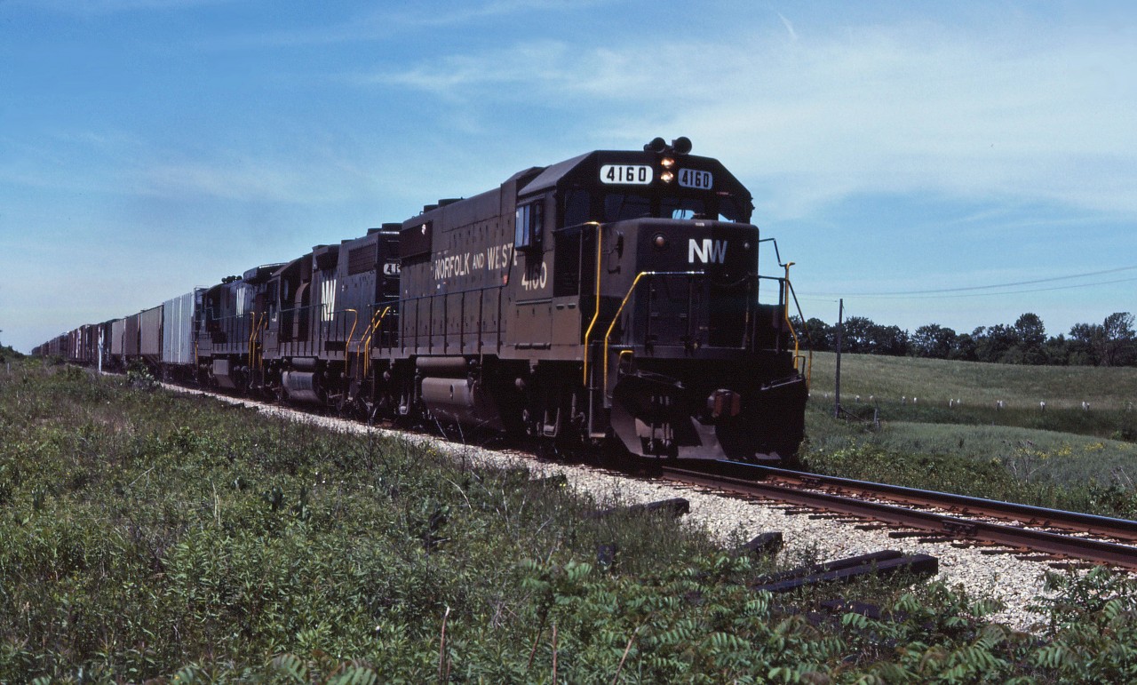 The Norfolk & Western-Southern Railway merger took place in June 1982; however, two years later, we see little sign of it as three black N&W units lead an eastbound train through Cayuga on their way from Windsor and St. Thomas to Buffalo.