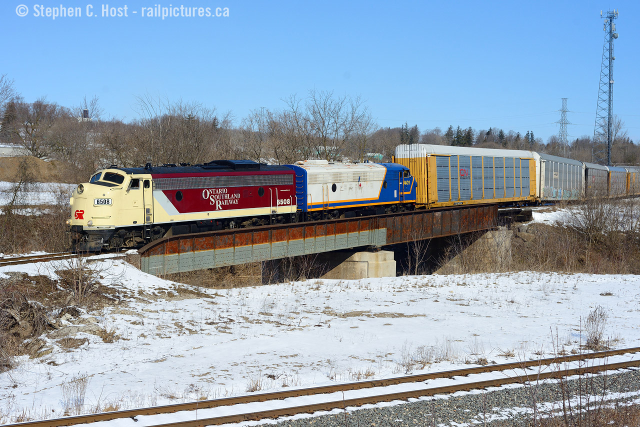 On my way to Sarnia I found OSR working, and heading to the CN - I knew right away I had to stick around for the above shot so my Family and I spent an hour waiting for it. This is a rarity and here's why: To shoot a train from this side, in sun, you only have a couple hours around the noon hour to get it - and of course by summer this angle is only doable  during *high sun*. Then you need OSR to run to CN to grab cars on the day shift, also somewhat rare, but happens as needed. But this isn't the CAMI job - it may as well be: Woodstock turn, due to a shortage of cars from CN (Sound familiar?) is now running as the CAMI switcher as needed as well as the usual Putnam/Woodstock turn. CAMI was EMPTY when I drove by looking for these guys, not a single autorack in the facility - I wondered if the plant is on strike - nope, it's not, just a CN car delivery shortage. On Saturday OSR ran the 1000 Woodstock Turn to CAMI to grab a dozen or so racks, spot them at CAMI, then run light power to CP to grab more autoracks and spot them at CAMI in the late afternoon. The CAMI job is basically abolished for now, but this could change very quickly. I didn't follow OSR for too long as I had to get to Sarnia - but don't they make it look good with this motive power? I can't get enough of it. So get this shot while you can - once OSR returns to normal it will be a difficult one to get.