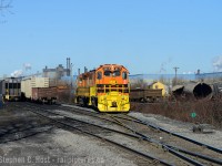 I'm in my element again - Snake's words: "Steel Steve" is back and this time I've followed a surprise SOR job that ran all the way to the east end of the line, first thing in the morning, on a weekend. I was niagara-region bound and heard them call DI for the hole - and diverted my attention to the North End with bells on. Usually this is a late afternoon job, so I'll take it! In 1998 I used to work down here, specifically the facility off to the right, as it was one of Philip Services many Hamilton branch offices that I supported for a summer job.<br><br>At right there are tank cars being scrapped by Triple M Metal. Also the feller at left walking over to talk to me; usually someone talks to me from a nearby business when I'm here to tell me what I can't take photos of, so I simply booked out of there. Public road, sorry boys and girls :)<br><br>And of course, that's the recently outshopped NECR 3840, now RLHH 2117 working in the first few weeks? since it arrived, with the GP39-2u 2301 trailing. Curious to those who know, why would a GP39-2 have a turbo? Sounded like it did. Cheers all :)