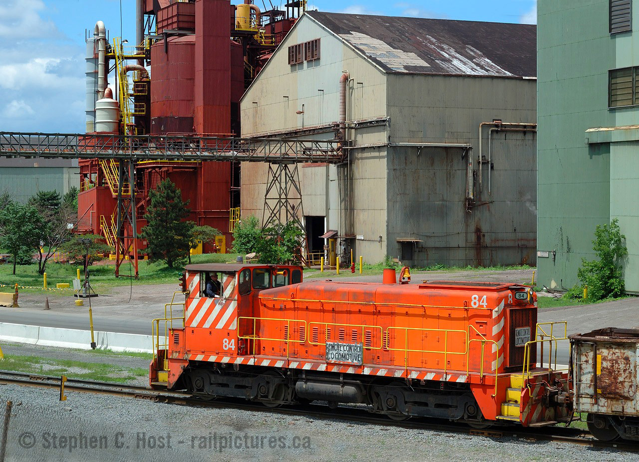 I've had an affinity for Hamilton's industrial core since I arrived in 1988 and wouldn't you know I spent quite some time in the last decade and change hunting (sometimes just driving through) for activity and toting my camera for rail and non rail action. With mixed results, some hunts went well, some not so well, but this was the ONLY time I was able to find Stelco units in action before US Steel repainted all of their equipment.
I posted another view of Stelco #84  a few years ago (With  minimal processing - this photo is what happens once you learn how to process!) and others such as Keith Maccauley have done the same, even Doug Page photographed #84  in 1959 on delivery (Built 11-59 - per TSG). Number 84  has lived its entire life within the confines of this facility in the employ of Stelco. But guess what? This is kind of a swansong, hopefully proven false, because rumours swirled that Stelco would switch to trackmobile, and guess what, they are now using a trackmobile. The fate and future of Stelco's GMDD SW's are now in the hands of the infidel's performance - I have my doubts if Stelco returns to life that it'll hold up - nearby CN Steel Centre switched from Trackmobile to  SW 1200 7304 in 2015 and the trackmobile was SLLLOOOWWW. We're now going to wait and see what happens.. if any of these units leave the property.. don't hold your breath for the return though.