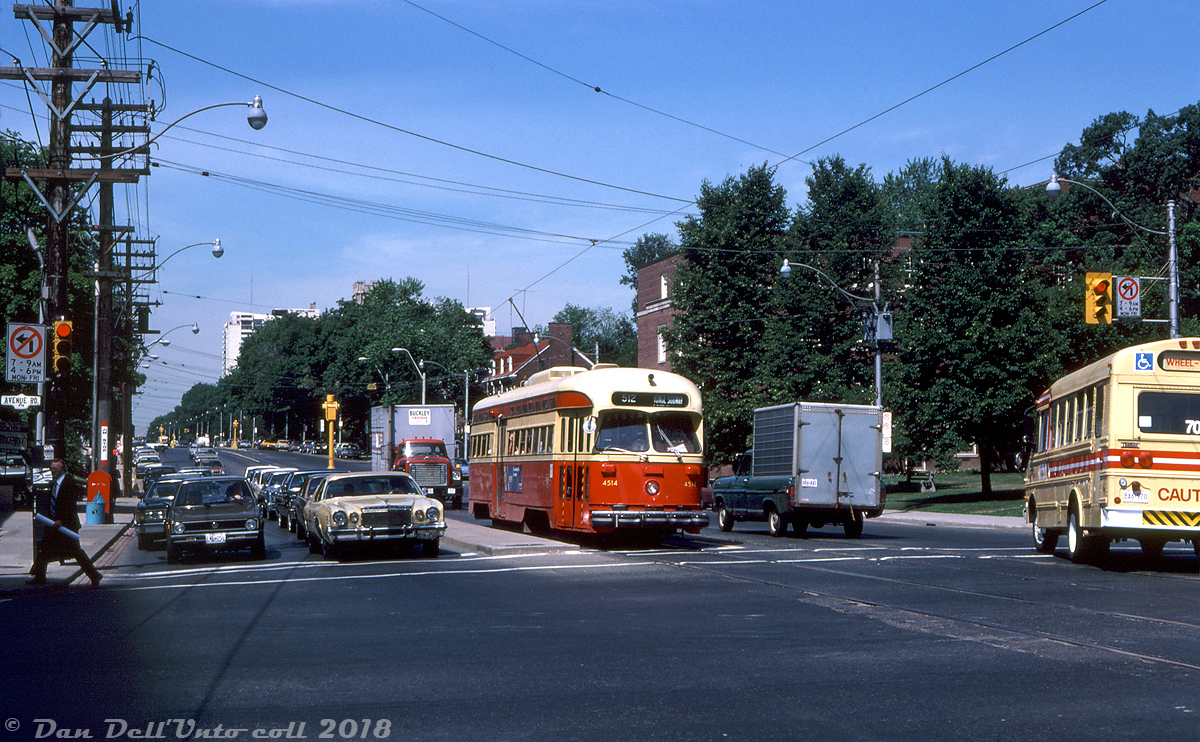 TTC A8-class PCC 4514 makes its way eastbound through leafy mid-town Toronto on St. Clair Avenue, stopped for the light at Avenue Road in traffic. Part of the the "newest" group of PCC's in the fleet, the 50 4500-series A8's were based out of Wychwood Carhouse and regularly saw service on the St. Clair route.Other notable things in this scene: the luxury of a mid-70's Chrysler Cordoba (no doubt from the posh Forest Hill area nearby) contrasting with the spartan econobox first generation Volkswagen Rabbit next to it. Also the tan and red bus on the right operated by All-Way Trans for the TTC, one of the earlier accessible "Wheel Trans" services operated in the city.Joe Testagrose photo, Dan Dell'Unto coll.