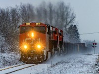CN 2949 is leading train 406, as they head through Apohaqui, New Brunswick, the morning after a snowfall hit Southern New Brunswick. With not much light left in the day, the colors of the CN locomotion really stand out from the dreary snow covered backdrop. 