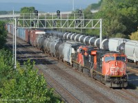 Twenty year old CN 5719 (SD75i) with CN 2343 (ES44dc) and CN2569 (C44-9w) leads train 422 under Oakville Sub signal 348T1, beside the west end of Aldershot yard.  Head end cars that 422 will drop off in the yard from Aldershot East include high-cube auto parts boxcars for the Ford Oakville Assembly Plant.   
