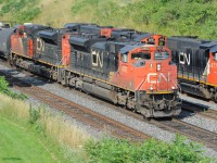 A matched set of SD70M-2's lead an eastbound CN freight train on track 2, past two GP38-2W and a GP9u pulling outbound Hamilton road switcher train CN 550 west along the Aldershot yard lead.  A total of 5 GMD built engines.  Train 550 will join the Oakville sub about a mile ahead at CN Snake, after the eastbound freight has cleared.  Mainline freight trains with all GMD power are the exception nowadays, though they still dominate in yards and road switching.
