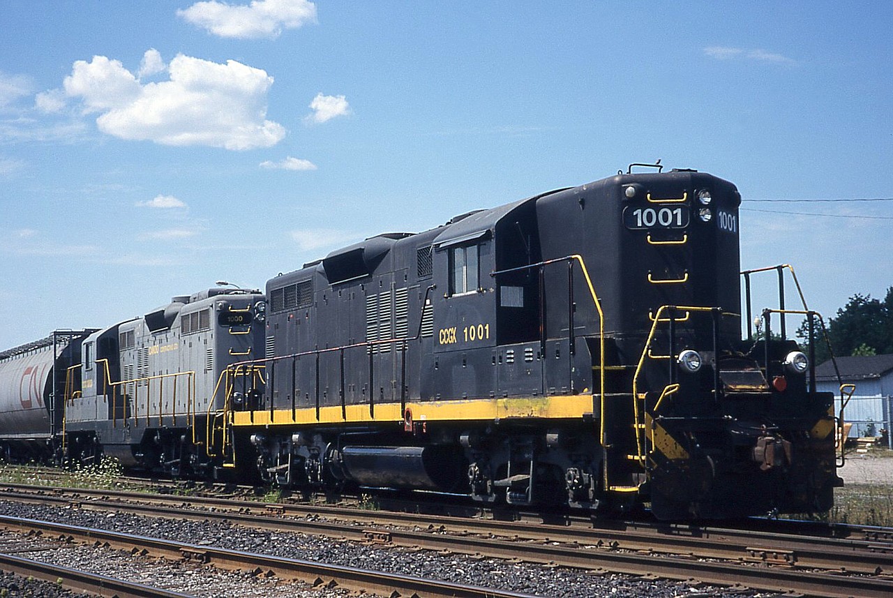 Steve's recently posted photo of the Orangeville-Brampton Railway (http://www.railpictures.ca/?attachment_id=32523) mentioned CCGX 1000, but did not mention CCGX 1001.  I'll admit I was confusing the Orangeville-Brampton Railway with the Barrie-Collingwood Railway, both operated by Cando Contracting.  We found CCGX 1001 and 1000 in Barrie, ON on August 2, 1998.  CCGX 1001 was still in patched Ohio Central paint, being former OHCR 94, originally built as B&O 6594.  GGCX 1000 was built as QNSL 157 and appears to still be in their grey paint.  GGCX 1000 is apparently now owned by Coco Paving in Millhaven, ON.  I don't know exactly where this photo was taken in Barrie, ON... I assume the former CN yard before the GO expansion to Barrie.
