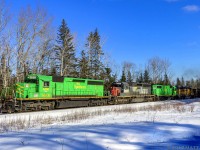 With a colorful lashup, NBSR 6318 is westbound, leading a New Brunswick Southern Railway freight at Vespra, New Brunswick. 