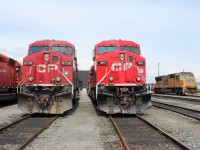 Contrasting old and new paint jobs between CP 8738 and fresh 9817 while a UP SD70M #3908 sits off to the side.