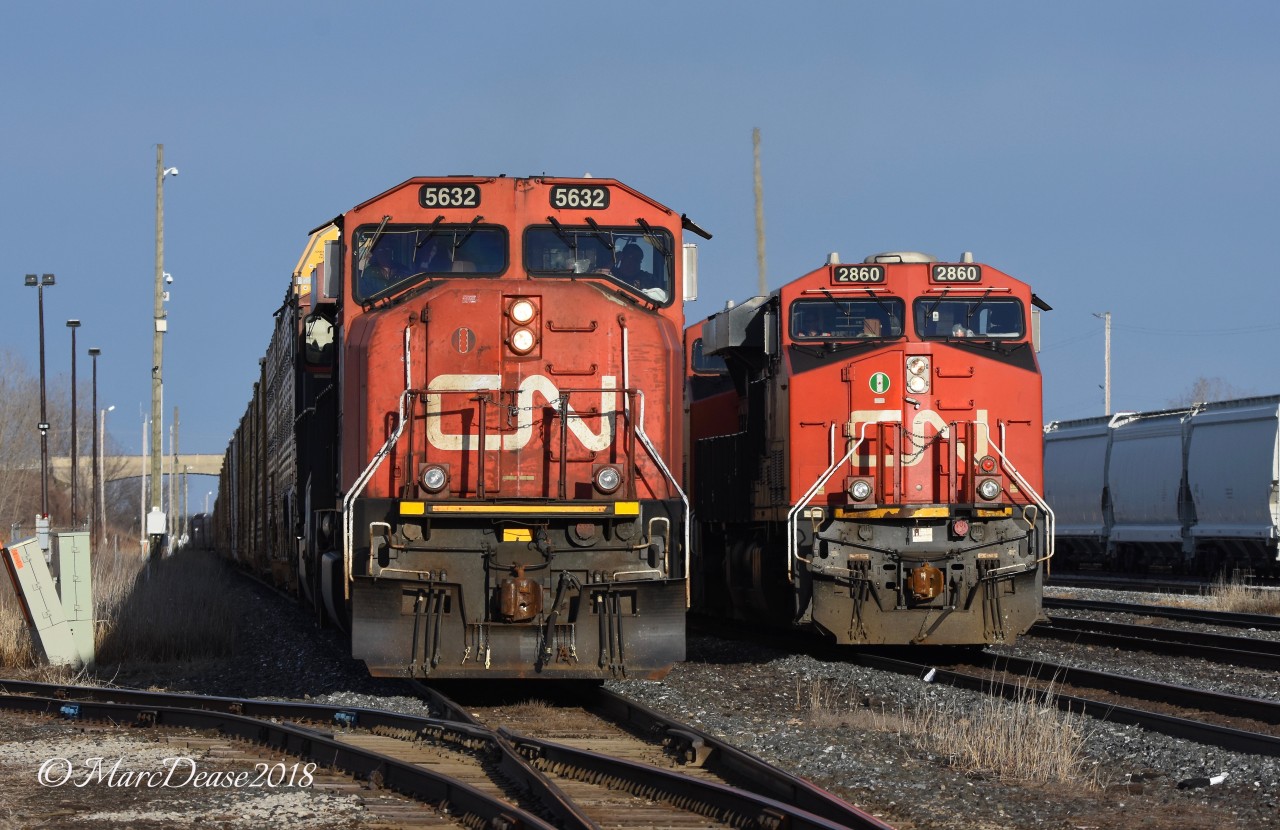 CN 5632 with CN 2276 lead train 371 through Sarnia as Train 385 with CN 2860 puts its train together in the yard.