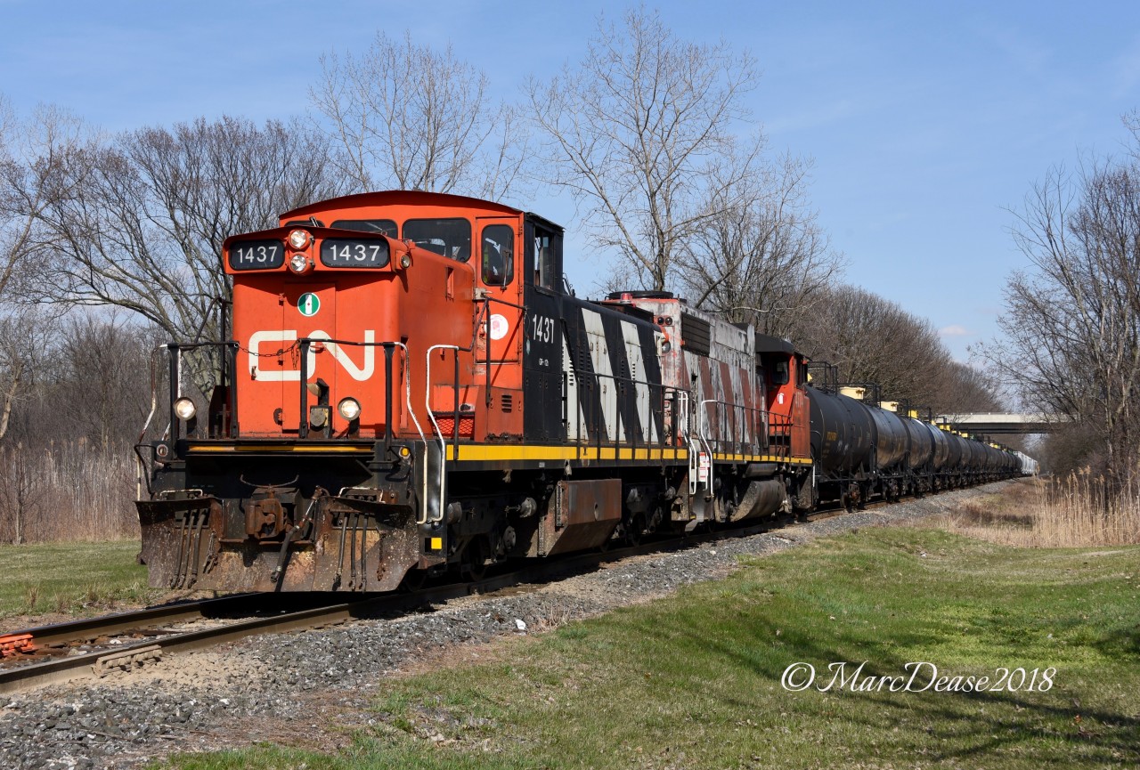 CN 1437 with CN 4774 depart Sarnia with service to Terra Industrial and NOVA Chemicals. They are about to cross Tashmoo Ave., before heading south down river.