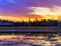 CN 8878 leads stacker train Q120, as they head through Memramcook, New Brunswick, with a colorful sunrise adding a nice backdrop to the shot. 