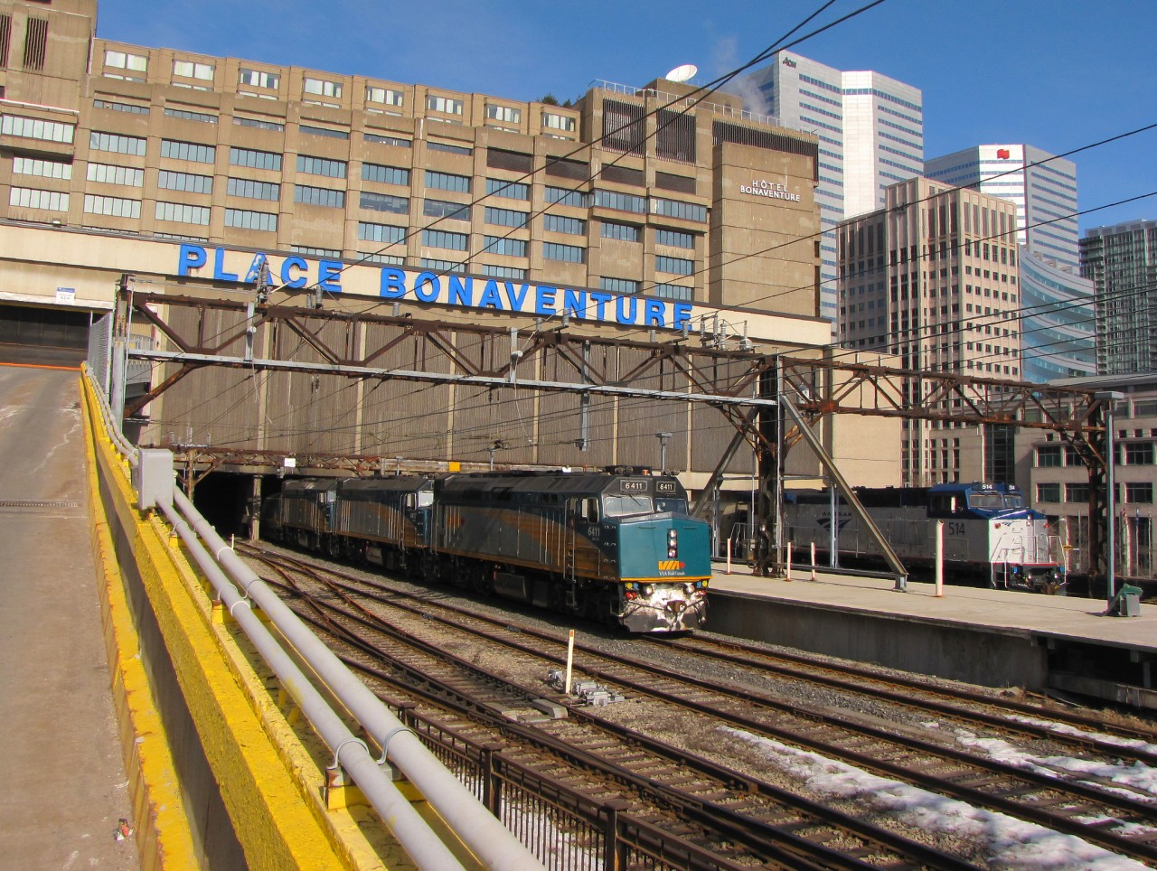 Amtrak "The Adirondack" is seen leaving Place Bonaventure and VIA's Ocean is unloading its final passenger after backing into the station. An uncommon practice when this photo was taken.