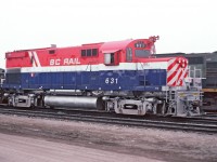 On the shop track at Prince George, a misty morning and perhaps some smog from the pulp mills. BCR 631 sporting fresh paint and a fancy headlight arrangement. Dual seal beam headlights as well as ditch lights. Also the unit has been adapted for operating a slug in yard service.