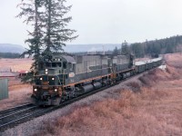 Early morning meet at Mackin. Train No 38, the "OV" symbol on the last few miles from Prince George to Williams Lake BC. Appears that they made a substantial pickup of copper concentrate, loaded in covered gondolas at Gibraltar. The crew will change off at Williams Lake and the train will continue on over two more subdivisions and terminate in North Vancouver. I was on the north bound "VO" from Williams Lake to Prince George and will return later that evening on the OV and perhaps have a meet here again the next early morning. On the left is Springfield Ranch and beyond that is the Fraser River.