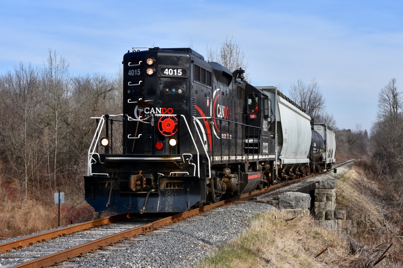 CCGX 4015 has just passed through the Inglewood and is rolling through the farmlands of Cheltenham ON heading south to interchange with CP. In this scene they are approaching Olde Base Line rd and crossing over a bridge which a peaceful looking river lies beneath on a beautiful spring morning. 
Time: 9:03am