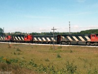 A mixed-bag lashup of CN M420 2512, F7Bu 9198, and GP9's 4579 and 4403 handle train #412, heading eastbound on the Guelph Sub east of Guelph in August 1984.