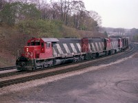 Nice combination of power, SD40 5067 leads GP38-2 5584 and 5574 around the curve at Bayview, running off the CN Oakville Sub westbound onto the Dundas on a dreary day many years ago. The lead unit eventually went to the New Brunswick East Coast, and the trailing units were renumbered in 1988 to 4784 and 4774 respectively.