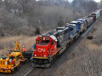 CN M38531 10 headed up the grade towards Hardy with CN 5450, IC 2462, GECX 7785, and 155 cars. The mega tie gang can be seen working on the north track