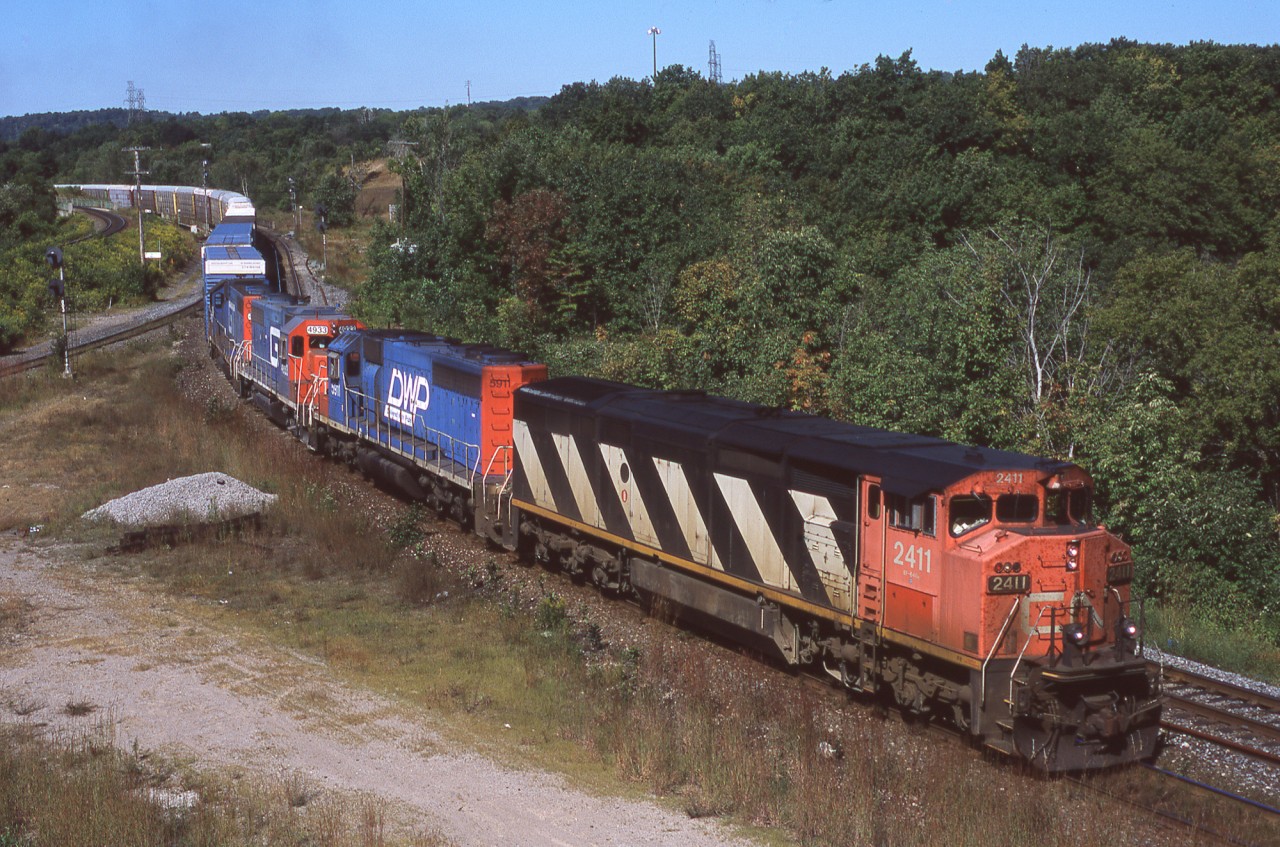 CN 396 snakes its way through Hamilton West with a nice lashup consisting of CN 2411, DWP 5911, GTW 4933, GTW 4927.