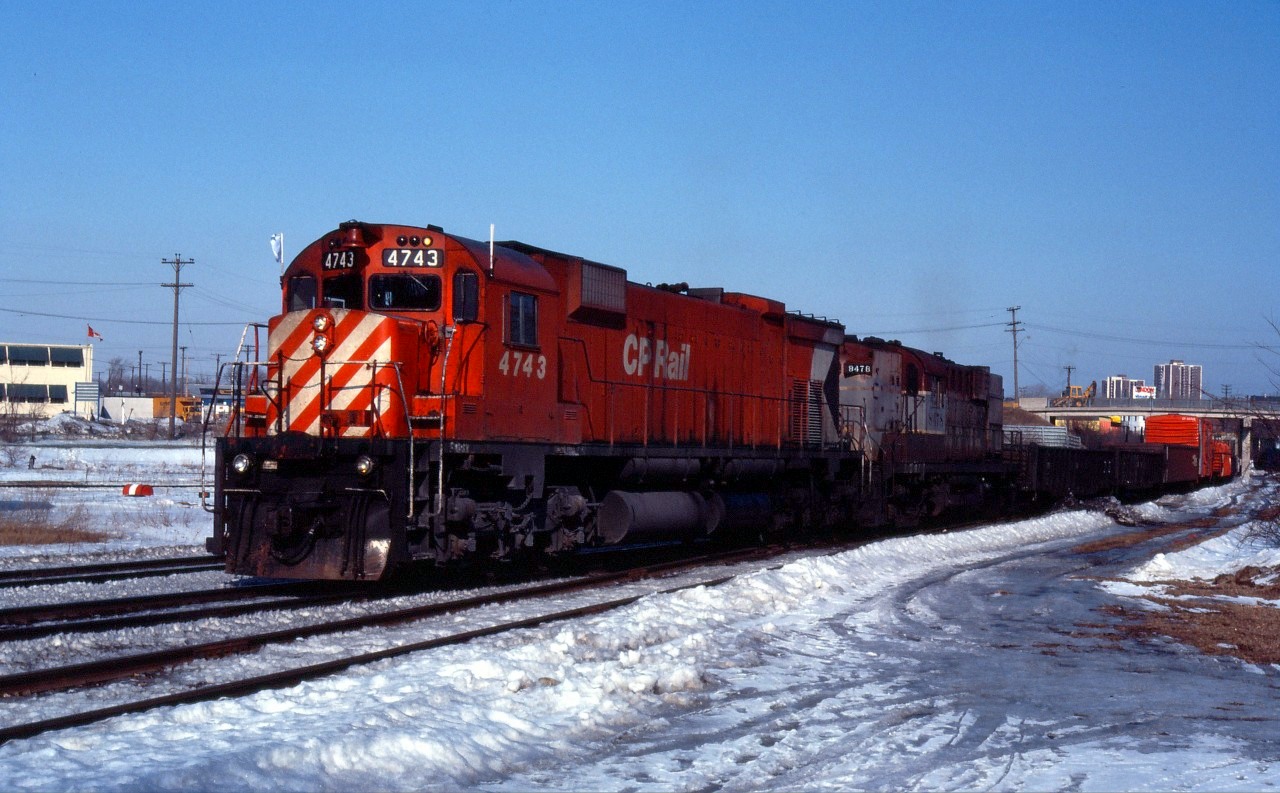 An extra passes through the signal plant near the TH&B's Chatham Street roundhouse during the winter of 1982. At this time, CP's RS10s were running off their last miles and this steam generator equipped unit, made surplus by VIA's November 1981 service cuts a few months earlier, is now in freight service. M636 4743, the last M630 unit built for CP, is accompanied by RS10 8478 (still in maroon and gray).