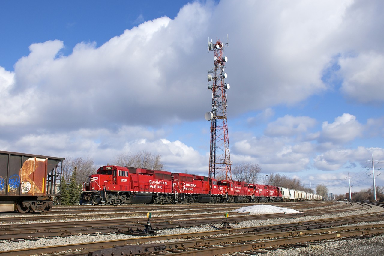 CP F95 is on its way to the Lacolle Sub as it passes the Lasalle Yard with five geeps for power (CP 2260, CP 2280, CP 3053, CP 4428 & CN 2262), two of which will be set off at Delson. It is passing a multimarked hopper, four of which have been in the yard since last fall.