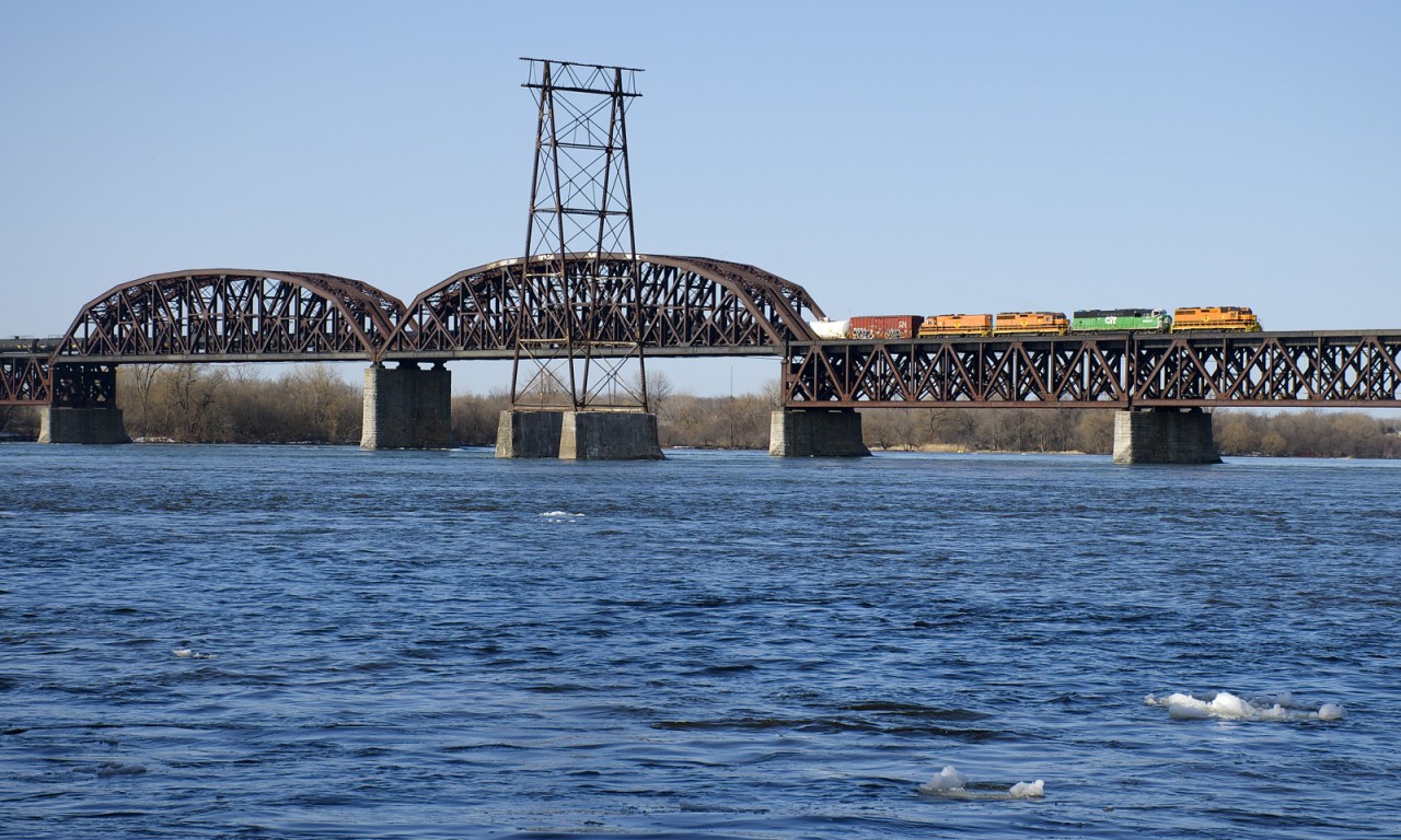 Reports indicate that the washed out SLR bridge at Bromptonville, Qc may reopen within a couple of days, meaning this SLR 393 may be the last detour to enter Montreal. Power is QGRY 3105, CBFX 6028, SLR 3803 & SLR 803 as the train crosses CP's bridge across the St. Lawrence River.