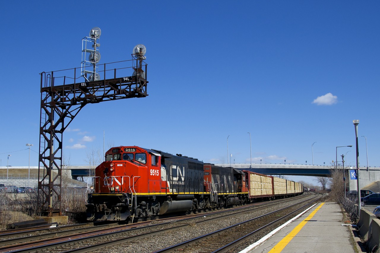 CN 9515 & CN 4703 lead CN 585 under a signal gantry at Dorval with mixed freight for Brockville.