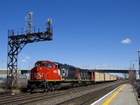 CN 9515 & CN 4703 lead CN 585 under a signal gantry at Dorval with mixed freight for Brockville.