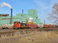 Dwarfed by the towering green Dofasco buildings, the venerable SW1200 shoves a cut of cars back towards the steel centre building for loading.  CN 7304 is one of only three SW1200's on the CN system; the other two reside in Mac Yard.