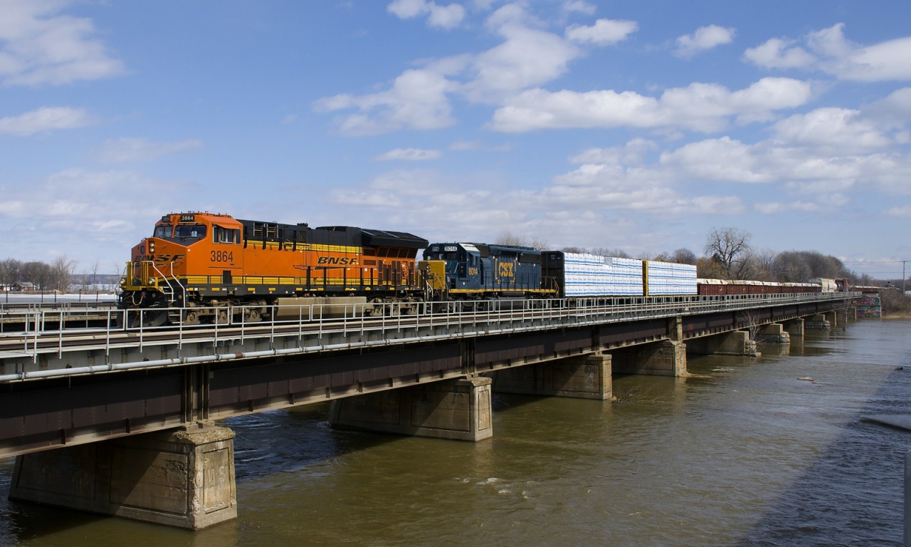 BNSF 3864 and CSXT 8014 are the power on a 77-car CN 327 which is crossing the Ottawa River.