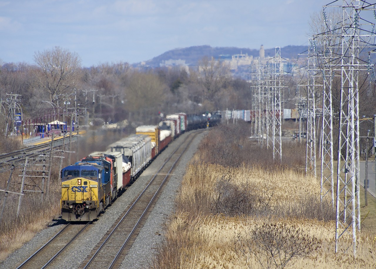 CSXT 7885, CSXT 4749 & CN 2230 are the power on run-through train CN 327 as it rounds a curve in Pointe-Claire.