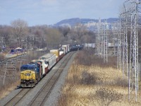 CSXT 7885, CSXT 4749 & CN 2230 are the power on run-through train CN 327 as it rounds a curve in Pointe-Claire.