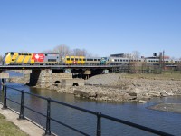 P42DC VIA 916 and LRC coach VIA 3351 are both wrapped for VIA Rail's 40th anniversary as they bring up the front of VIA 635, seen crossing the Lachine Canal.
