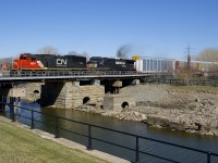 CN 5424 and smokey NS 9727 lead CN 401 over the Lachine Canal on a spring afternoon in Montreal (finally!). At the head end are loaded autoracks as always.