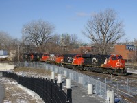  CN 120 has two geeps trailing (CN 9592 & CN 4760), along with the usual complement of GE power (CN 2959 leading, CN 2930 and CN 2911 fourth and fifth and CN 2965 mid-train). It is passing the railfans park beside the Pointe St-Charles Yard.