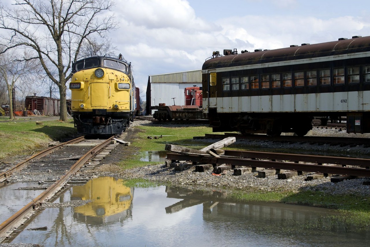 VIA 6309 is reflected in some spring melt-off at Exporail as the sun briefly peaks out.