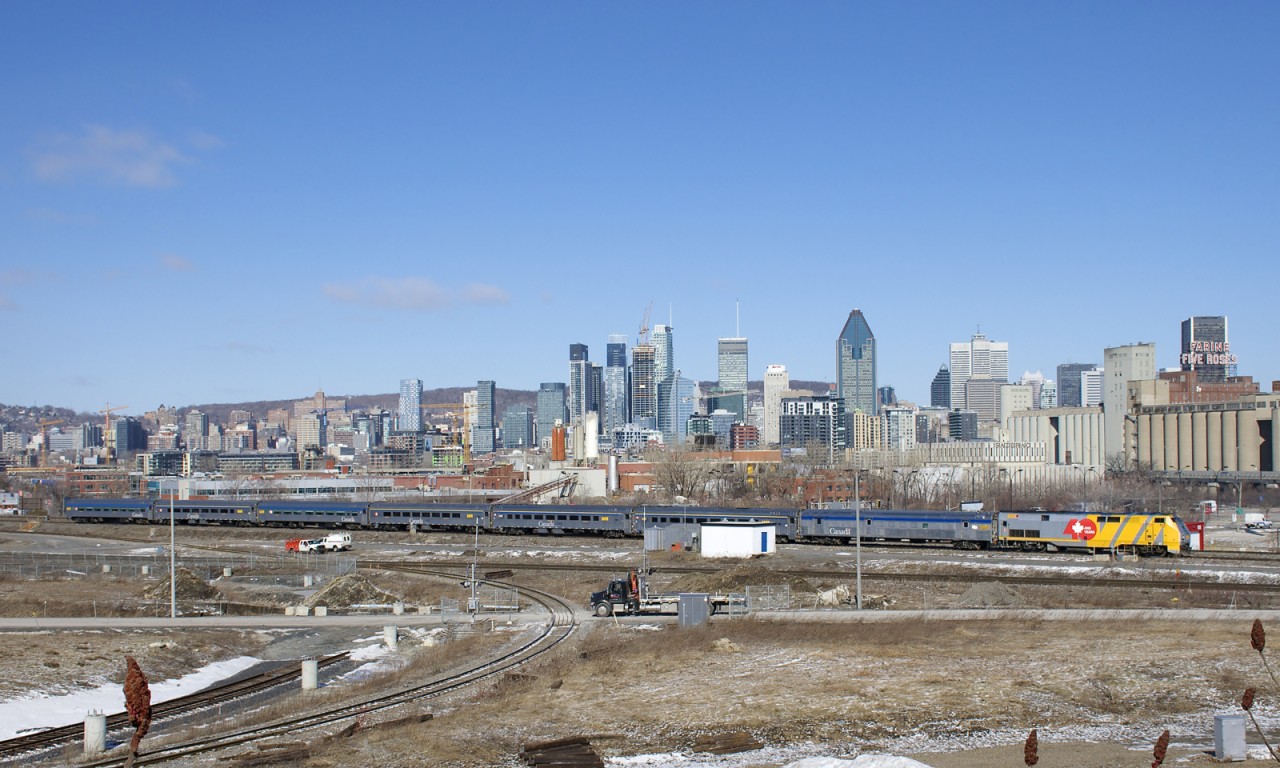 Wrapped for VIA Rail's 40th anniversary, VIA 914 pushes seven Budd cars as VIA 65 backs up towards Central Station in Montreal.