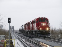 CP F94 is returning to Montreal after serving industries on the Lacolle Sub as it crosses the St. Lawrence River in the rain.