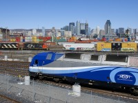 ALP-45DP AMT 1365 is doing some switching in the RTM's Maintenance Centre as GP9's CN 7726 & CN 4135 switch the parallel CN Pointe St-Charles Yard. Behind is the skyline of downtown Montreal.