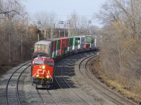 CN 3072 leads CN 120 around a curve on CN's Montreal Sub as it approaches Turcot West. Trailing is CN 8875 and mid-train is CN 3059.