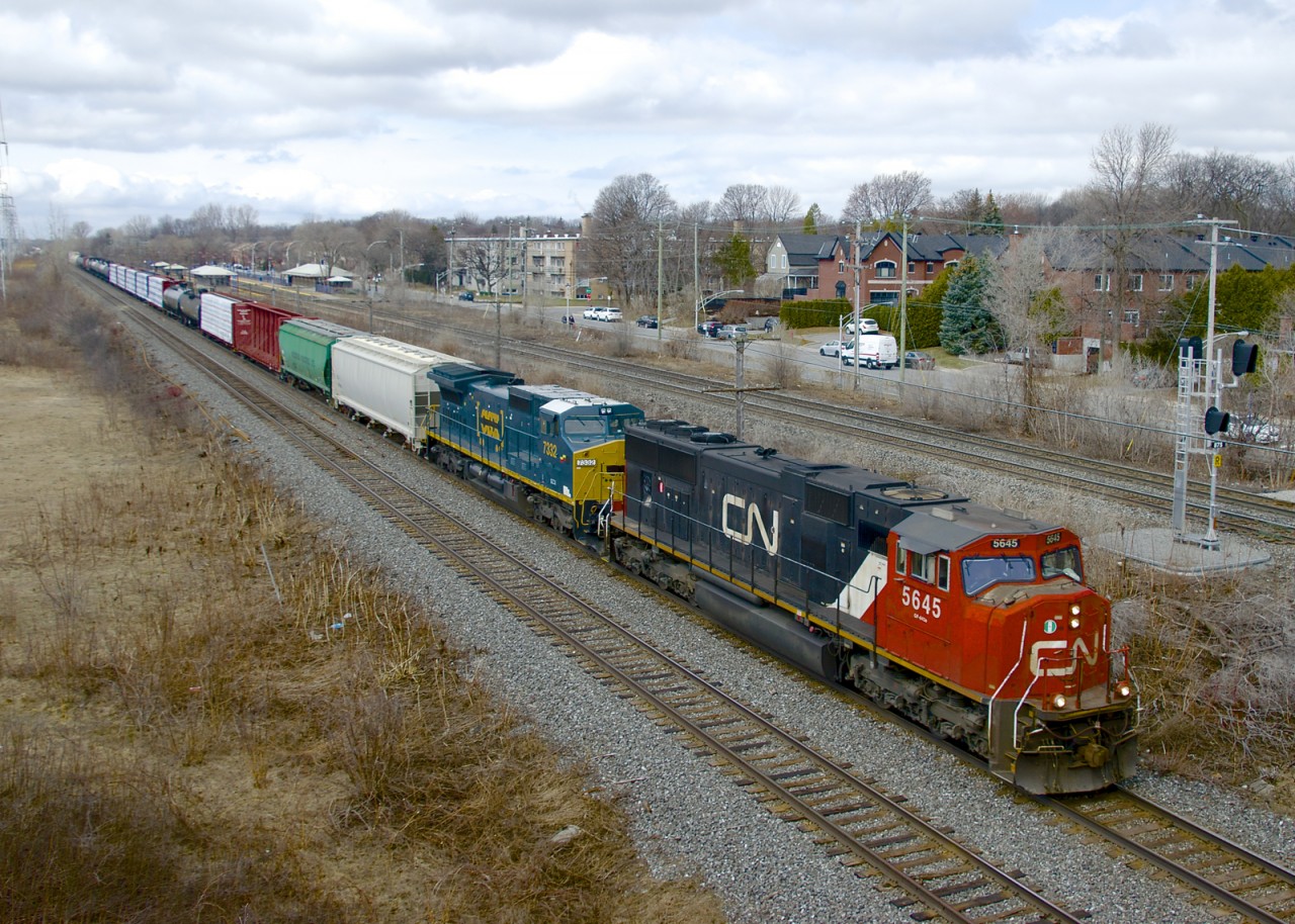CN 310 with CN 5645 and GECX 7332 (still with a Seaboard sticker from CSX's 'heritage' program) heads east through Pointe-Claire.
