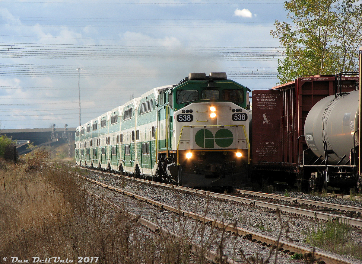 After running all afternoon back and forth between Toronto and Bramalea on the "Bramalea Flip", GO F59PH 538 blasts through Halwest with equipment move E864 (previously running in service as 281 to downtown Brampton, which we hopped off of at Bramalea) deadheading at track speed back down the Weston Sub to get to Toronto Union Station for its PM rush hour run up the Stouffville line. The train on the Halton-Weston connecting track on the right is CN #577, the daily transfer to CP West Toronto/Lambton Yards to interchange freight traffic between the two railways. It would usually be timed so as not to interfere with the afternoon Bramalea trains on the Weston Sub (many portions of which were still single track at the time), but sometimes SNAFUs did happen.  As per an old newspaper clipping in my collection, afternoon train service to Brampton (Bramalea Station) began on April 29th 2002 with 6 new midday trains and one early morning one. Most of the afternoon trains were cancelled effective April 1st 2010 and replaced with buses, to allow more time for work to be done on the West Toronto grade separation project. Service was gradually reinstated after completion, and today the Kitchener (former Georgetown) line hosts afternoon train service between Mount Pleasant and Toronto.