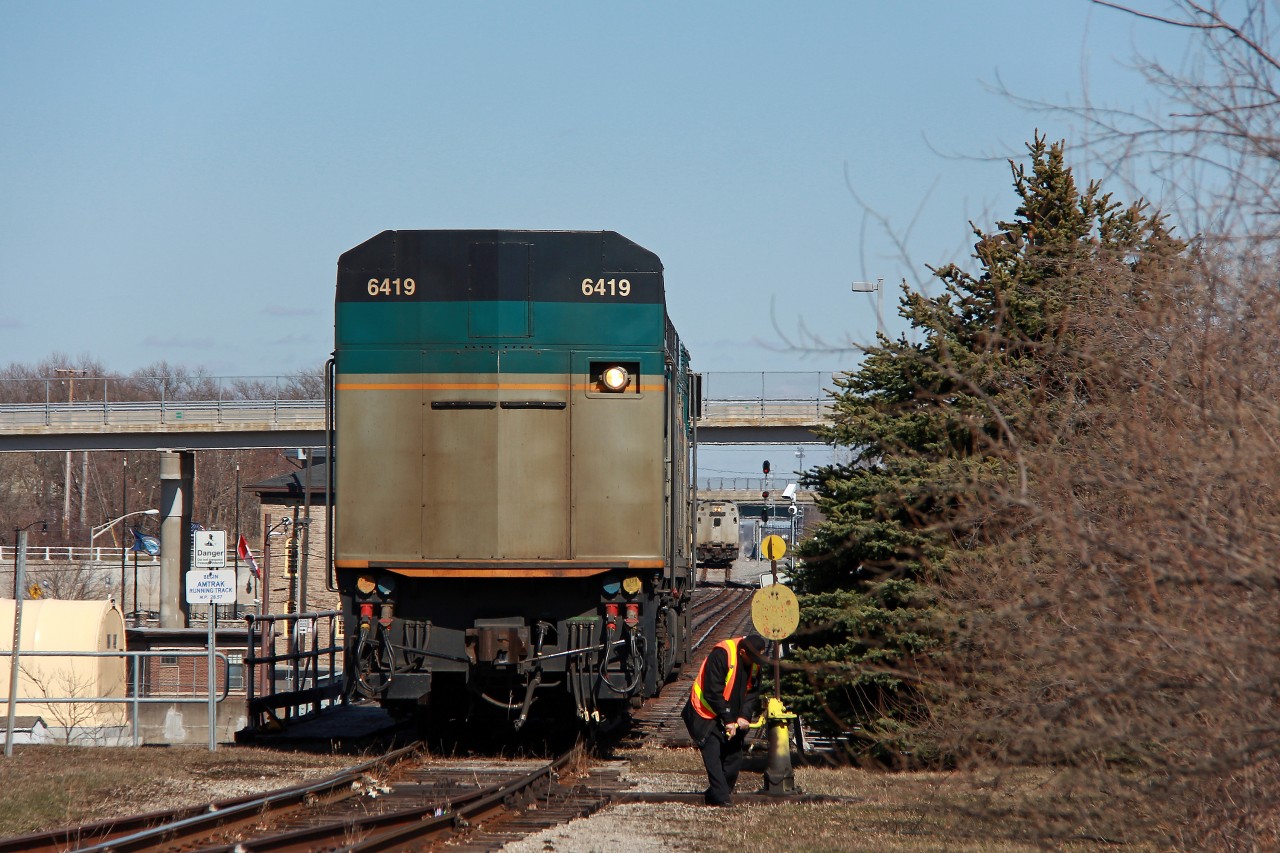 Divided by the Canadian and American border, locomotives of each country's national passenger railroads sit on their respective sides of the bridge.

Amtrak 121 was uncooperative and refused to pull the Maple Leaf back to the states on this morning. After hours of trying to resolve the situation, Via 6419 was finally placed on to lead the Maple Leaf to Niagara Falls. 

6419 has done its job, and one of Via's finest begins to throw the switch so 6419 can back into the siding. On the other side of the Whirlpool Rapids bridge on the American side is Amtrak 110. It will back across the bridge as soon as 6419 backs into the siding and the switch is realigned. It will take over the duties of Via 6419 to Albany-Rensselaer. 121 was coupled to the Maple Leaf alone at this point, still capable of providing HEP to the coaches, but unable to move under its own power. These type of movements are quite rare, but it is something Via and Amtrak have performed before. The majority of Amtrak's P42DC's are one to two years overdue for another rebuild or retirement, so perhaps this will become more frequent since it appears since neither seem imminent under Amtrak's budget woes.

Amtrak used two crews for this move, with one already on the Canadian side and the other in Amtrak 110. Since ownership of the Whirlpool's upper deck was transferred to Amtrak, the Via unit is technically in Amtrak territory, as the sign on the left adjacent to the bridge indicates. The Canadian flag is flying at half mast for the 16 people that lost their lives in the Humboldt Broncos bus tragedy, likely with each day dedicated to each life lost.

This move occurred only one half hour before the CBSA showed up for the arrival of Via 98. Known to be very territorial and precautious at the station, this shot most certainly would not have been possible if this switching move was done after they arrived. Since Via 97 arrived at Niagara Falls so late, it had to wait for Amtrak 63 (to become Via 98) to depart Niagara Falls, NY. Amtrak 64 (formerly Via 97) left Niagara Falls after the CBSA arrived, anticipating boarding Amtrak 63. The CBSA was very clearly confused, seeing the power was at the other end. They wandered about talking to the crews, and even hopped on the train at one point, probably under the assumption the passengers were Canadian arrivals on 63. Thankfully, the poor passengers, already seven hours late, did not have to deal with confused CBSA guards. The American CBP still await them however.