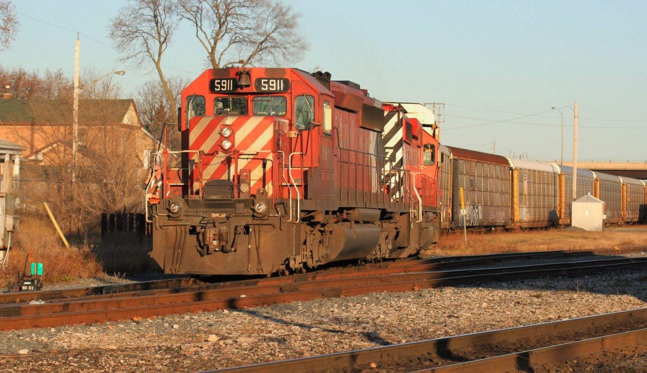 Canadian Pacific train T69 is seen departing Galt, Ontario with SD40-2’s 5911 and 6067, both wearing different versions of the classic multi-mark paint scheme.